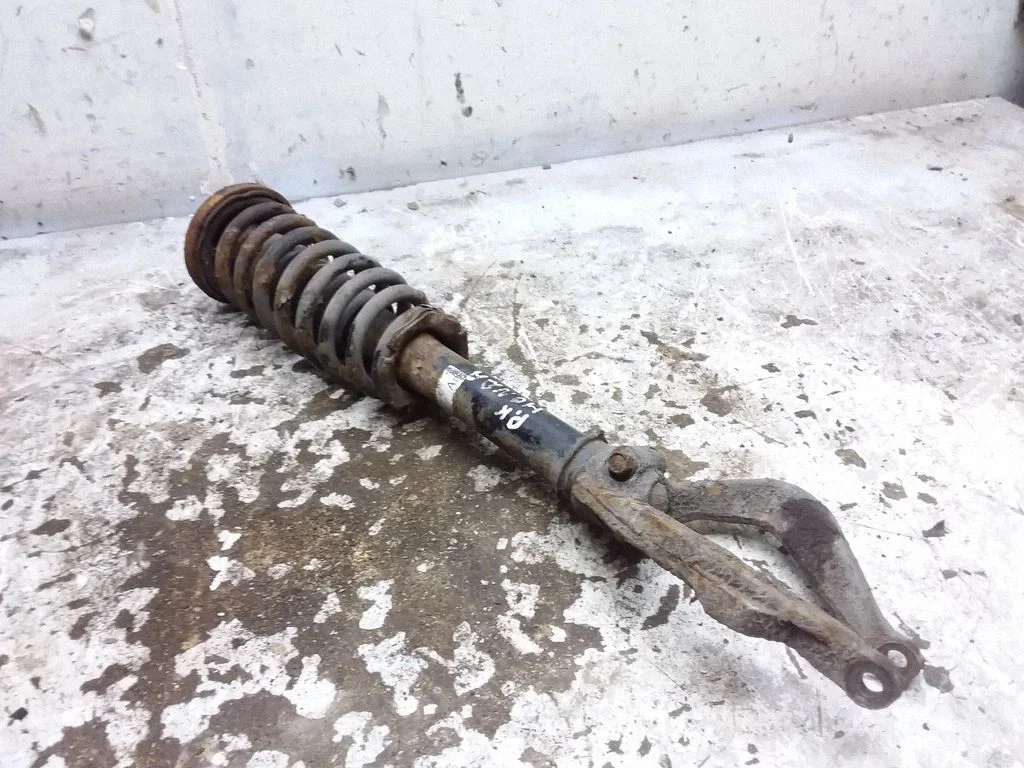 Front shock absorber with coil spring – front left
