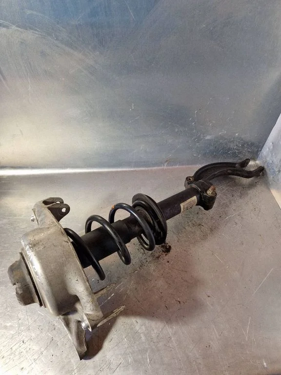 Front shock absorber with coil spring – left