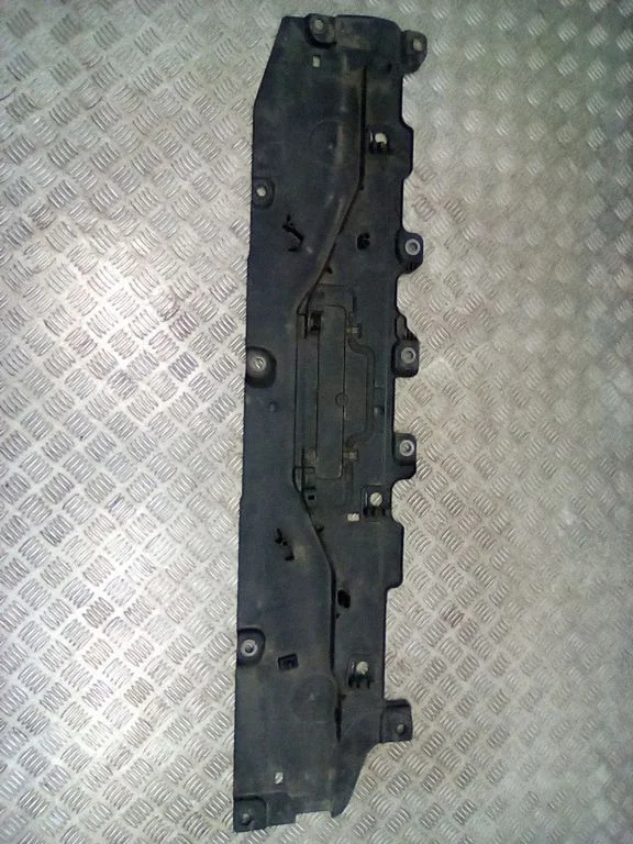 Center/middle under tray cover – left
