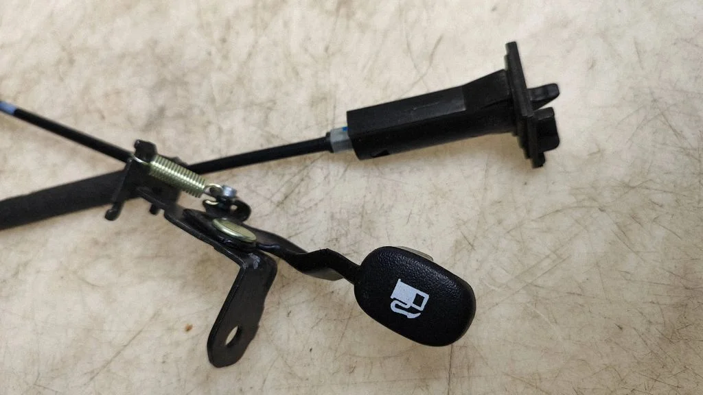 Fuel cap flap release cable