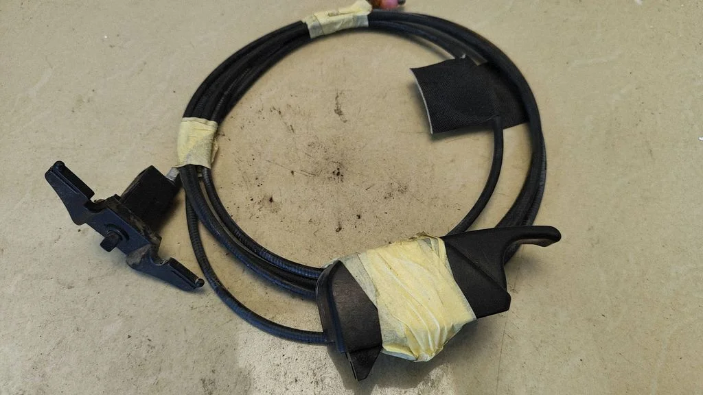 Fuel cap flap release cable