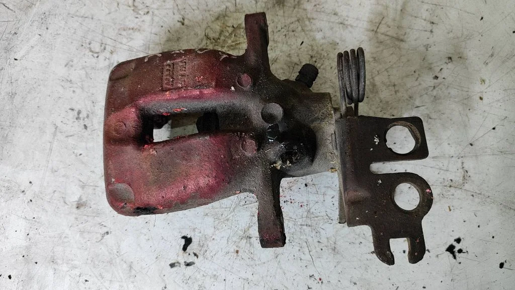 Rear brake caliper – left
