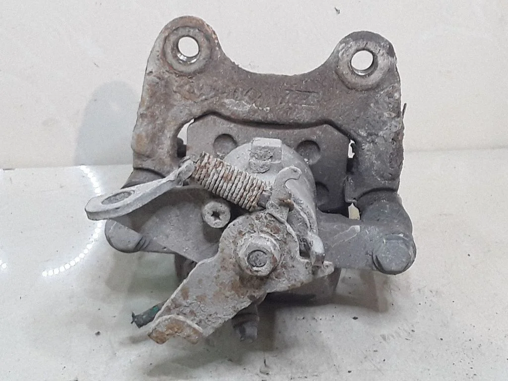 Rear brake caliper – left