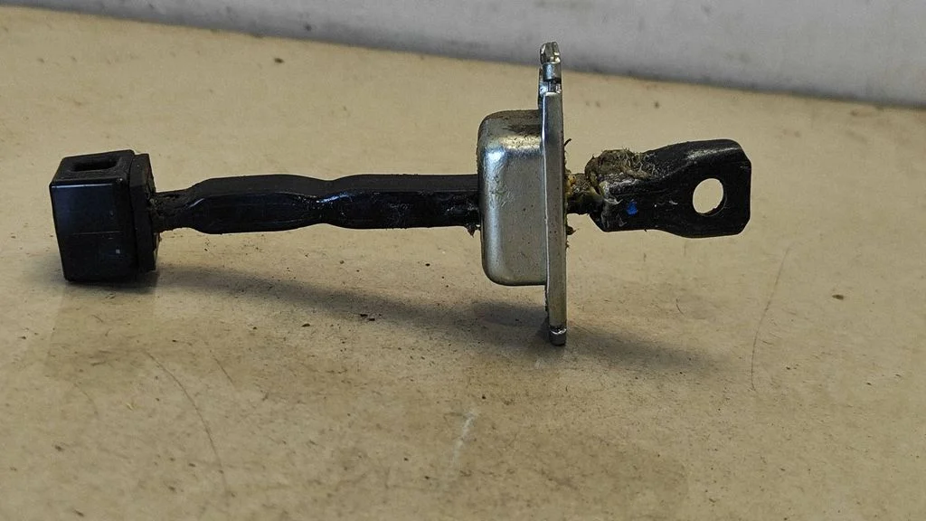 Rear door check strap stopper