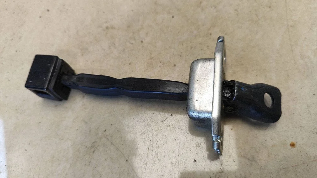 Rear door check strap stopper