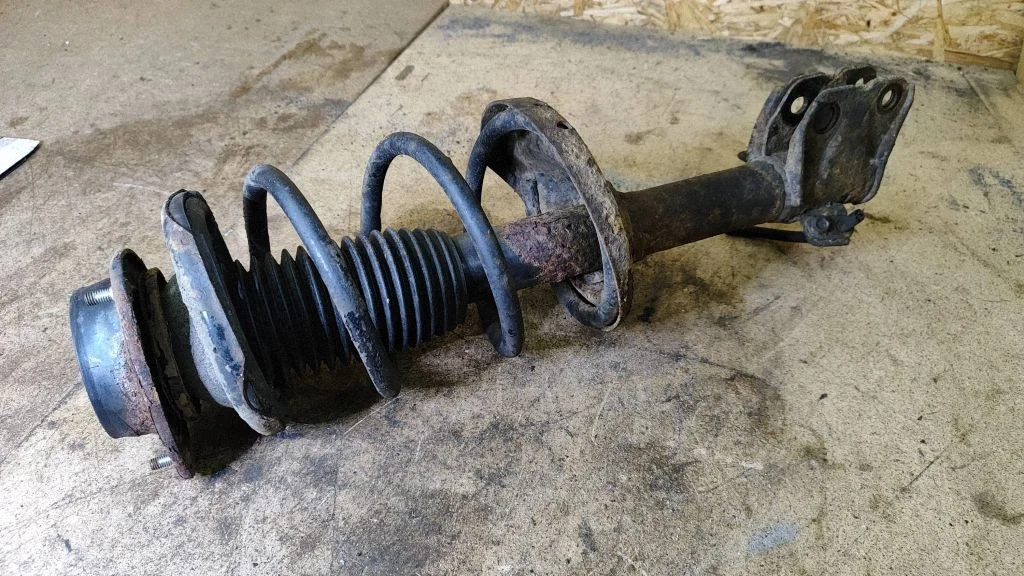 Front shock absorber with coil spring – left