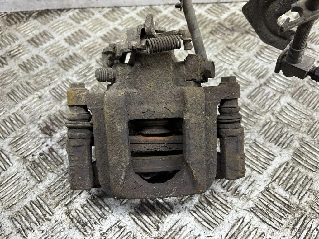 Rear brake caliper – left