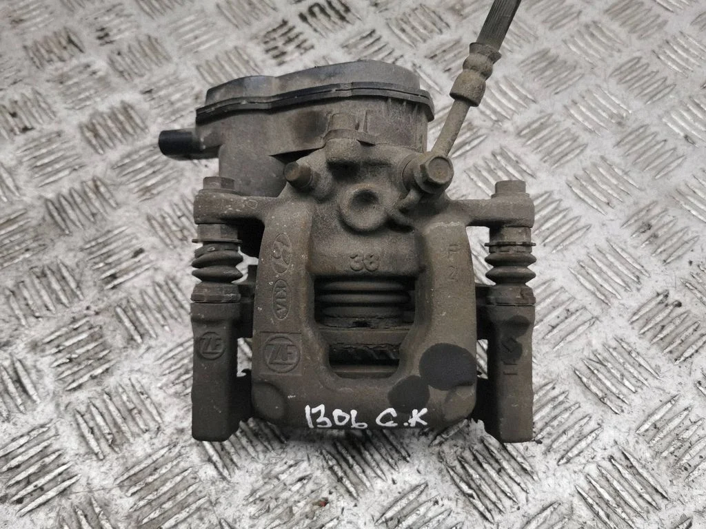 Rear brake caliper – left