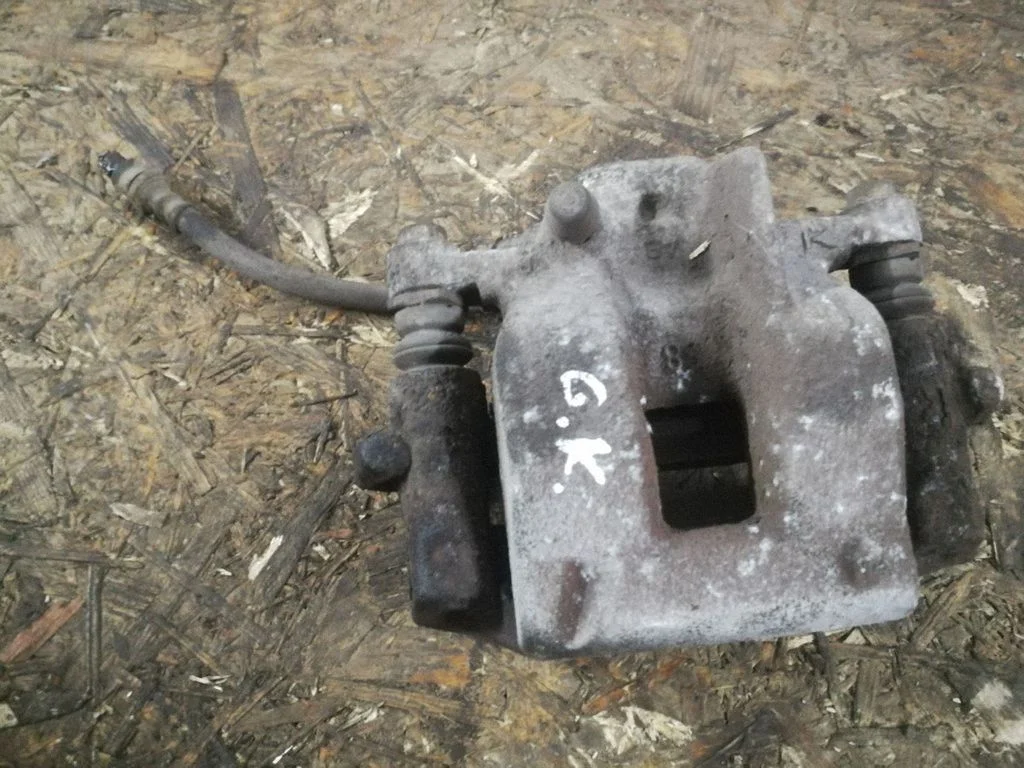 Rear brake caliper – left