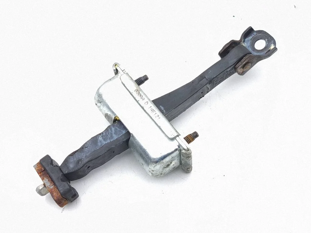 Front door check strap stopper – left