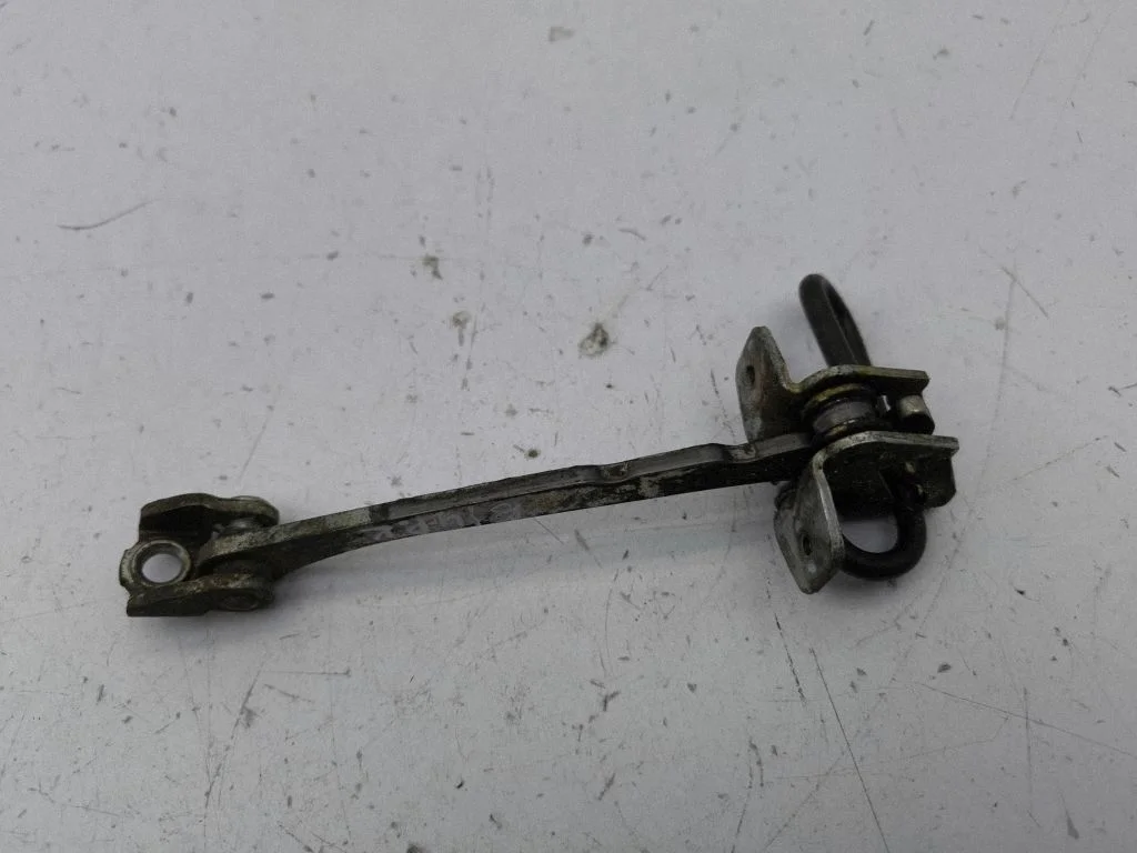 Front door check strap stopper – left