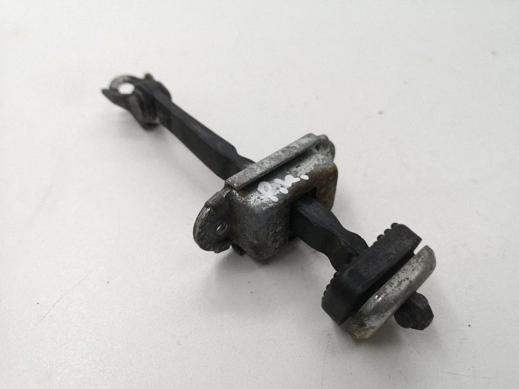 Front door check strap stopper – left