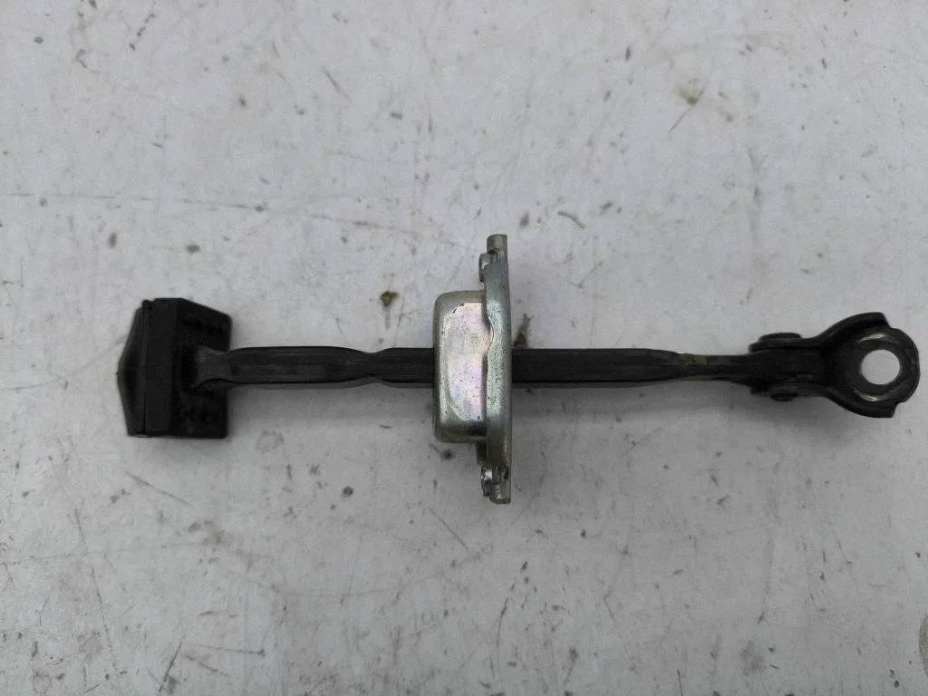 Rear door check strap stopper – left