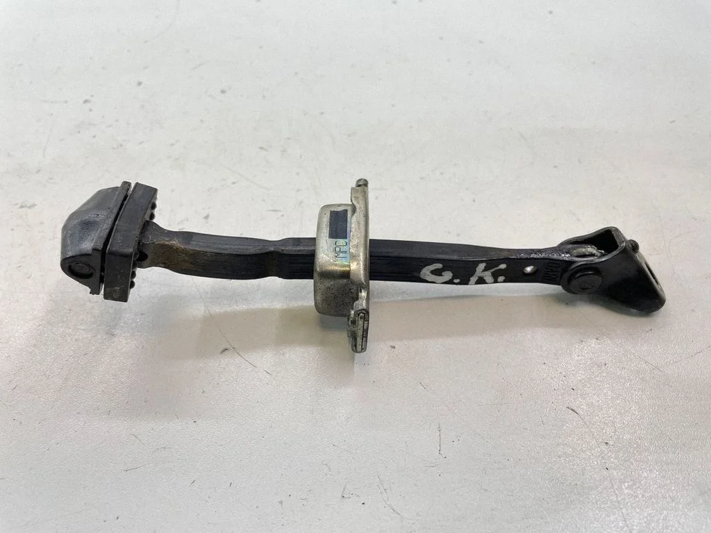 Rear door check strap stopper – left