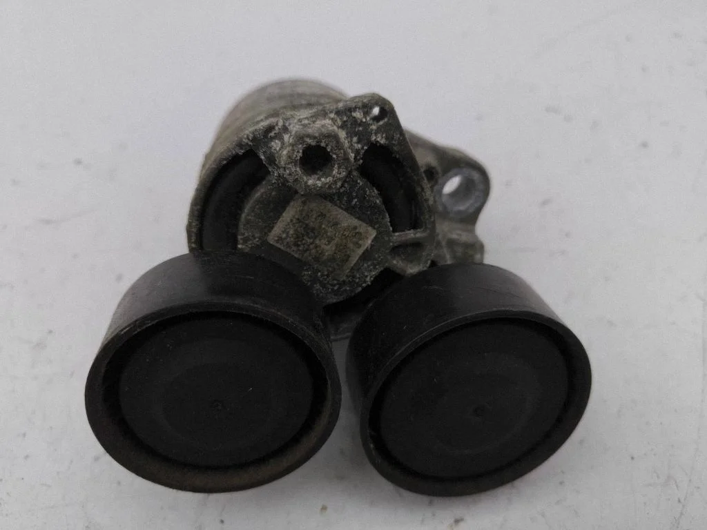 Alternator belt tensioner