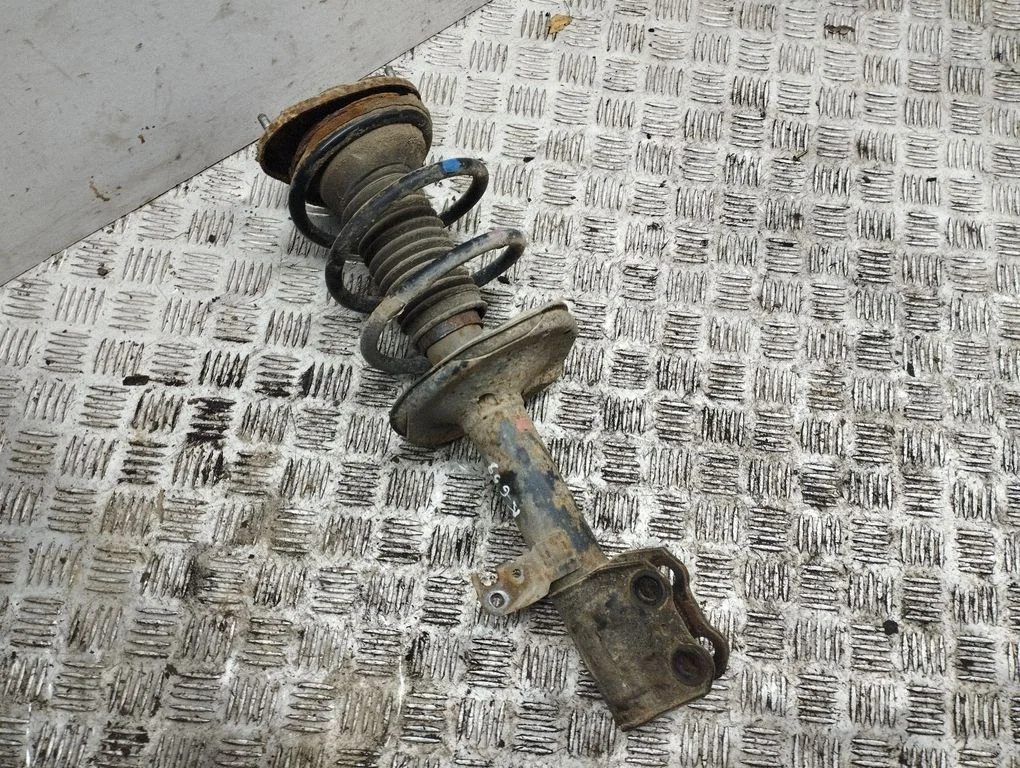 Front shock absorber with coil spring – left