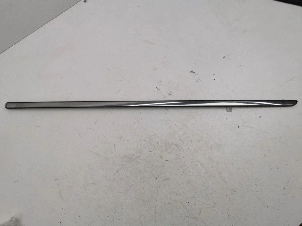 Rear side glass trim – left