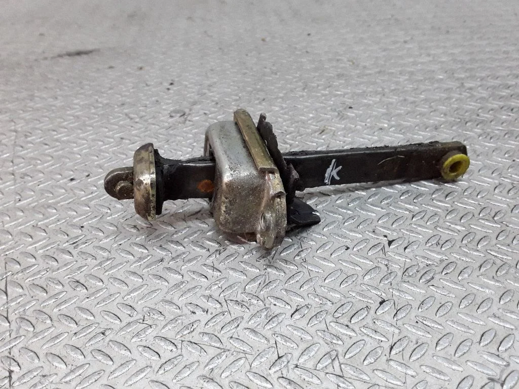 Front door check strap stopper – left