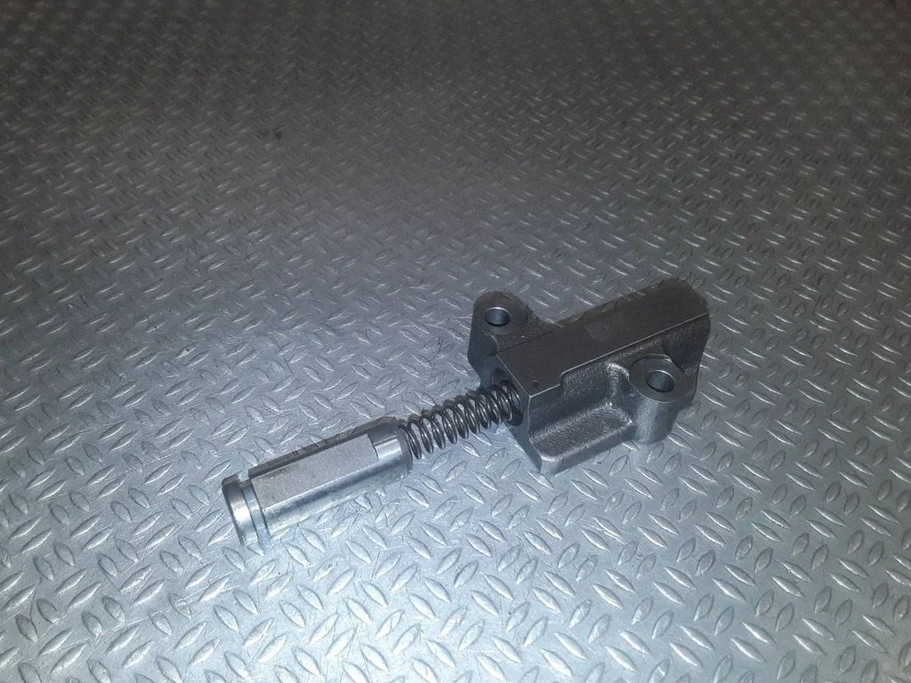 Timing belt/chain tensioner