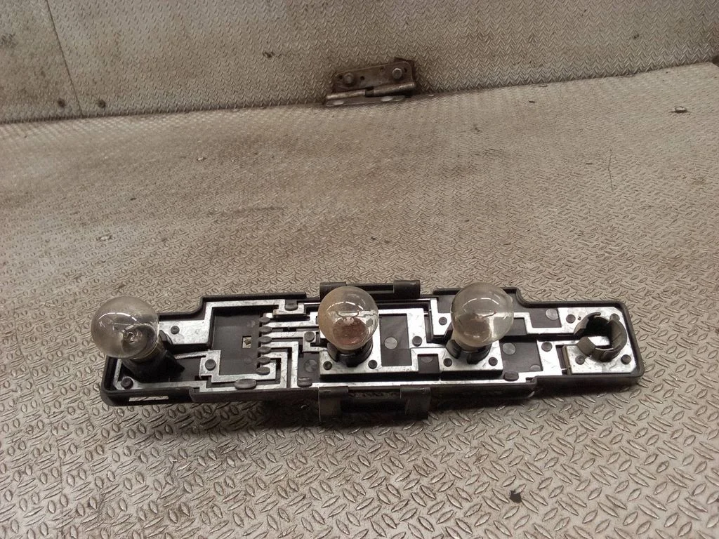 Tail light bulb cover holder – right