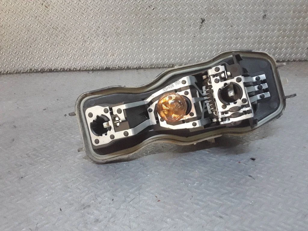 Tail light bulb cover holder – right
