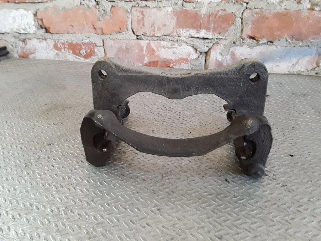 Front Brake Caliper Pad/Carrier – left