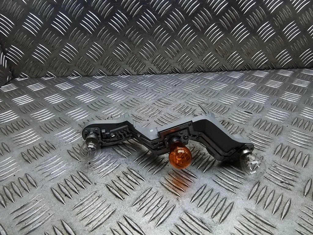 Tail light bulb cover holder – right